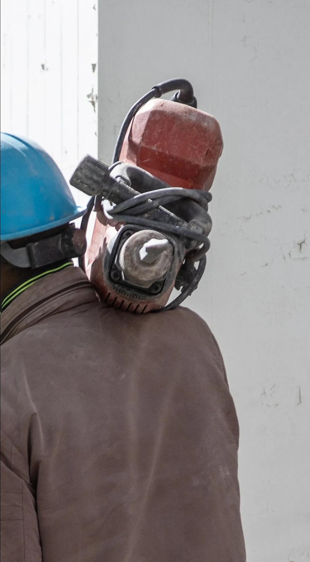 A Cut 'N Core crew member operating concrete cutting equipment